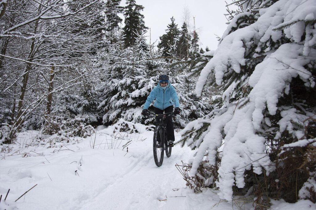 Woman cycling in the snow