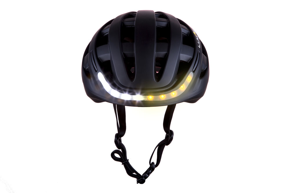 Black Lumos Kickstart bike helmet with front lights on Black Lumos Kickstart bike helmet with front lights on