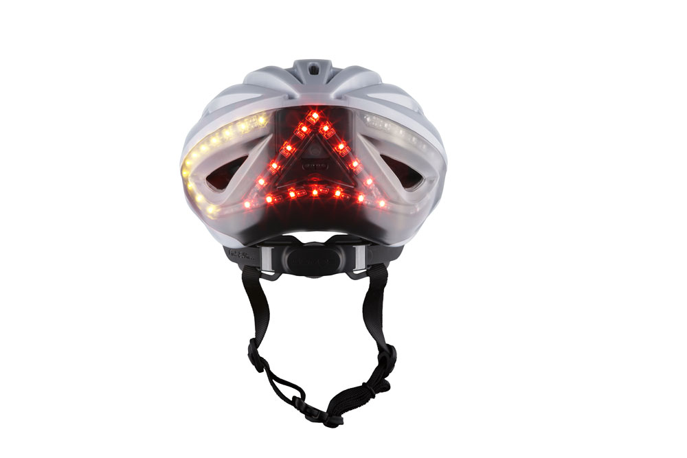 White Lumos Kickstart bike helmet with rare lights on White Lumos Kickstart bike helmet with rare lights on