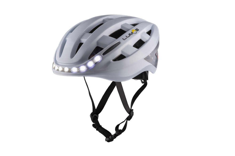 White Lumos Kickstart bike helmet profile with front lights on White Lumos Kickstart bike helmet profile with front lights on