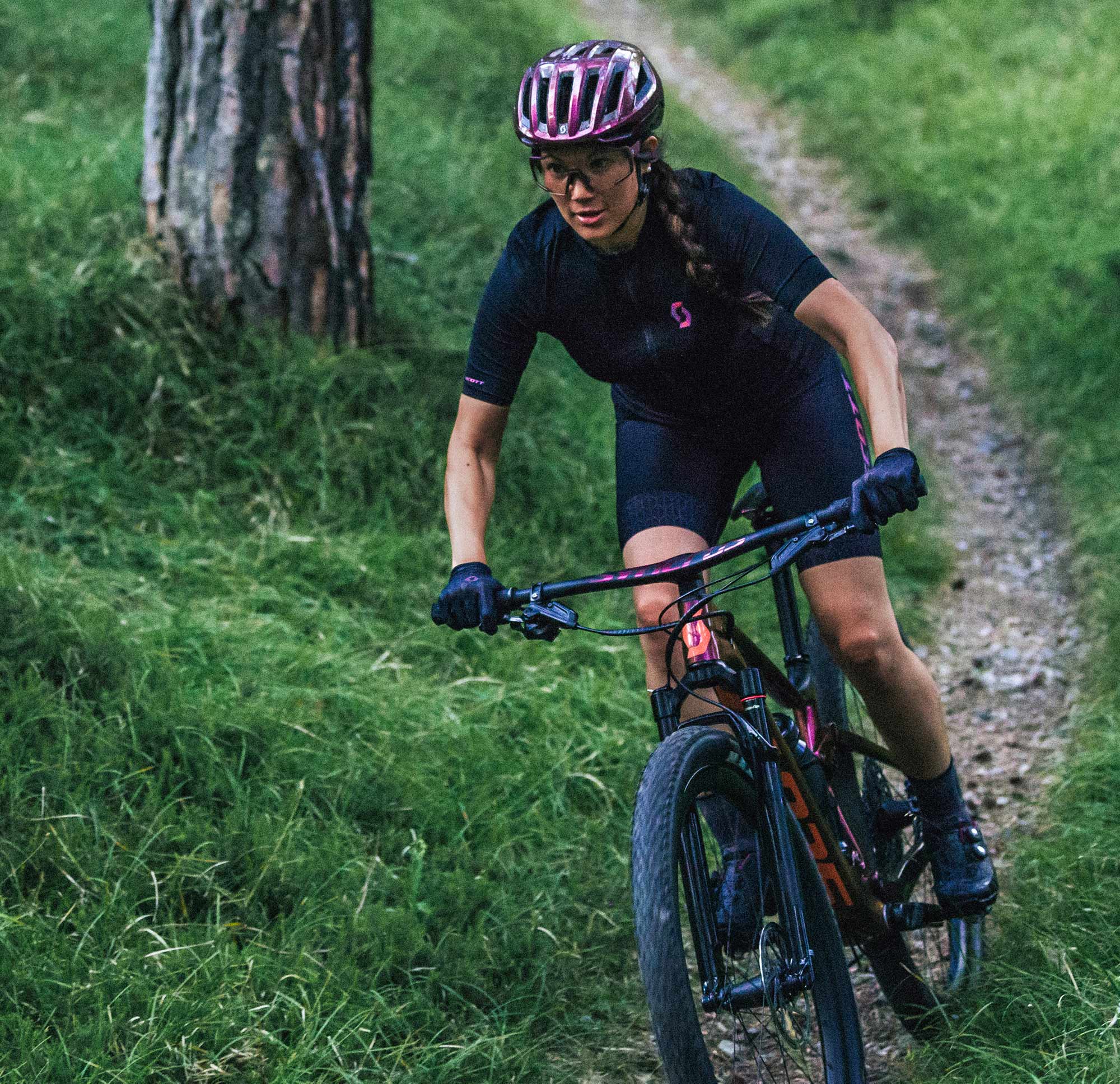 Woman riding a MTB in the forest Woman riding a MTB in the forest