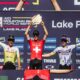 Finn Treudler celebrates on the podium, proudly raising the trophy for his U23 triumph in Lake Placid.